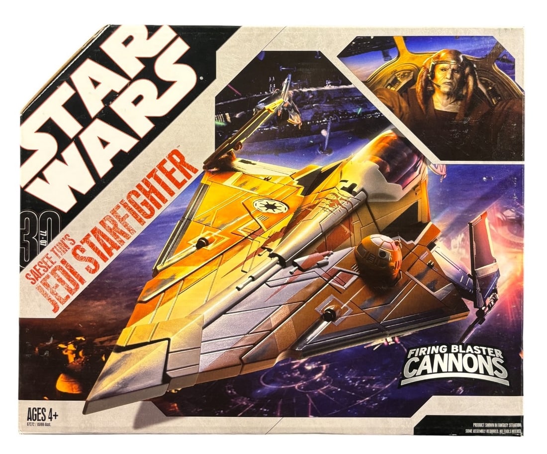 Star Wars 30th Anniversary Saesee Tiin-s Jedi Starfighter, Hasbro, 2006: A Star Wars 30th Anniversary -Saesee Tiin-s Jedi Starfighter- plastic toy vehicle, produced by Hasbro in 2006. Presented in its original cardboard packaging. The front features a large graphic of the