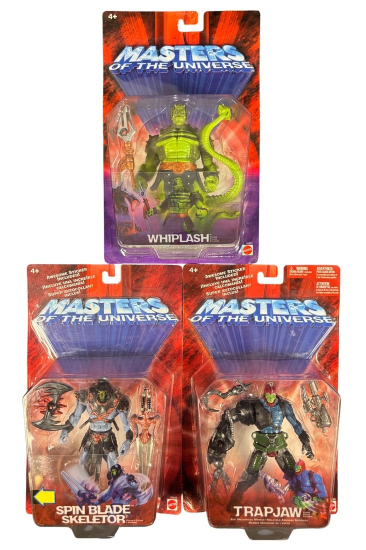 3 Mattel Masters of the Universe 200x Action Figures: Whiplash, Spin Blade Skeletor, and Trap Jaw: A group of three Mattel Masters of the Universe 200x action figures, each presented new and unopened in its original blister packaging. The figures, made of plastic, depict characters Whiplash, Spin B
