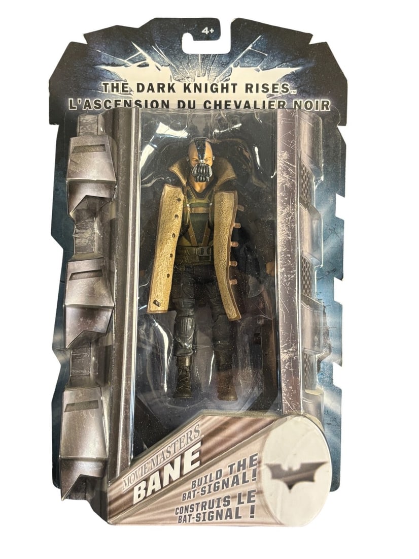 Mattel Batman the Dark Knight Rises: Bane Movie Masters Action Figure, Sealed in Original Packaging: A Mattel -Movie Masters- action figure depicting the character Bane from -The Dark Knight Rises- -L-Ascension du Chevalier Noir-. The figure is presented sealed within its original plastic blister pac