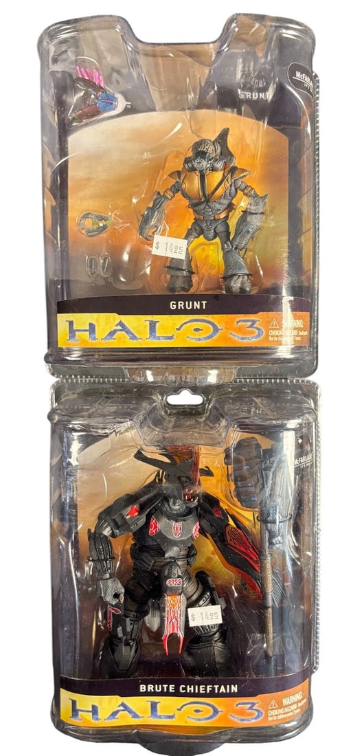 A Pair of Mcfarlane Halo 3 Action Figures: Brute Chieftain and Grunt: A pair of McFarlane Toys -Halo 3- action figures, comprising a Brute Chieftain and a Grunt. Each figure is sealed within its original clear plastic blister packaging with cardboard backing. The Brute