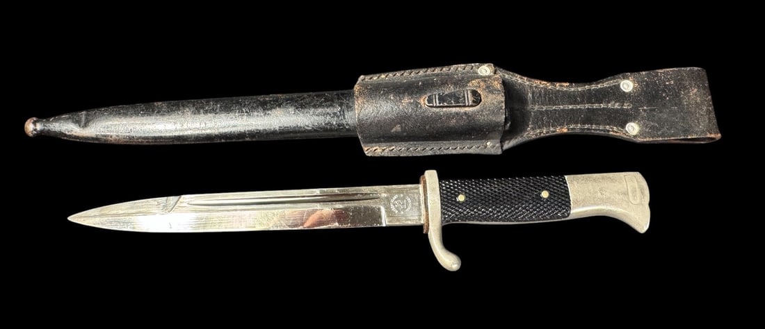 WWII German SS Dress Bayonet with RZM Markings by Robert Klaas Solingen: German World War II SS Dress Bayonet, complete with its original scabbard and leather frog. While superficially resembling a standard K98 dress bayonet, this specific piece is identified by its offici