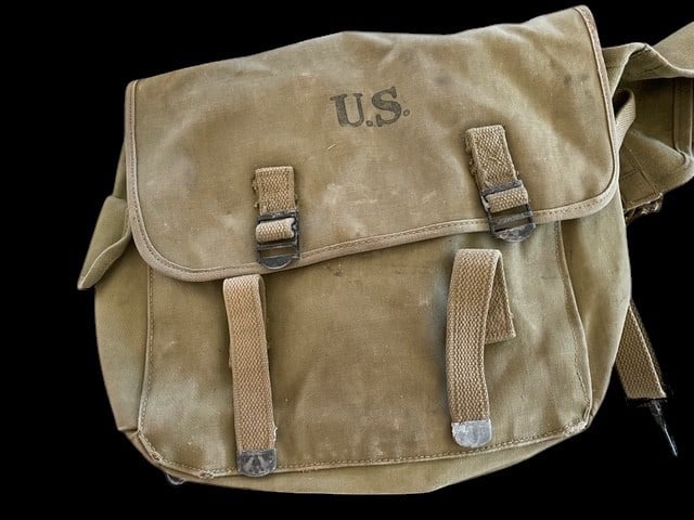 WWII U.S. Army M-1936 Musette Bag and Shoulder Straps Dated 1942: M-1936 Musette Bag and its companion M-1936 Combat Suspenders or shoulder straps. The musette bag is constructed of durable khaki canvas duck material and features the prominent U.S. stamp on the fron