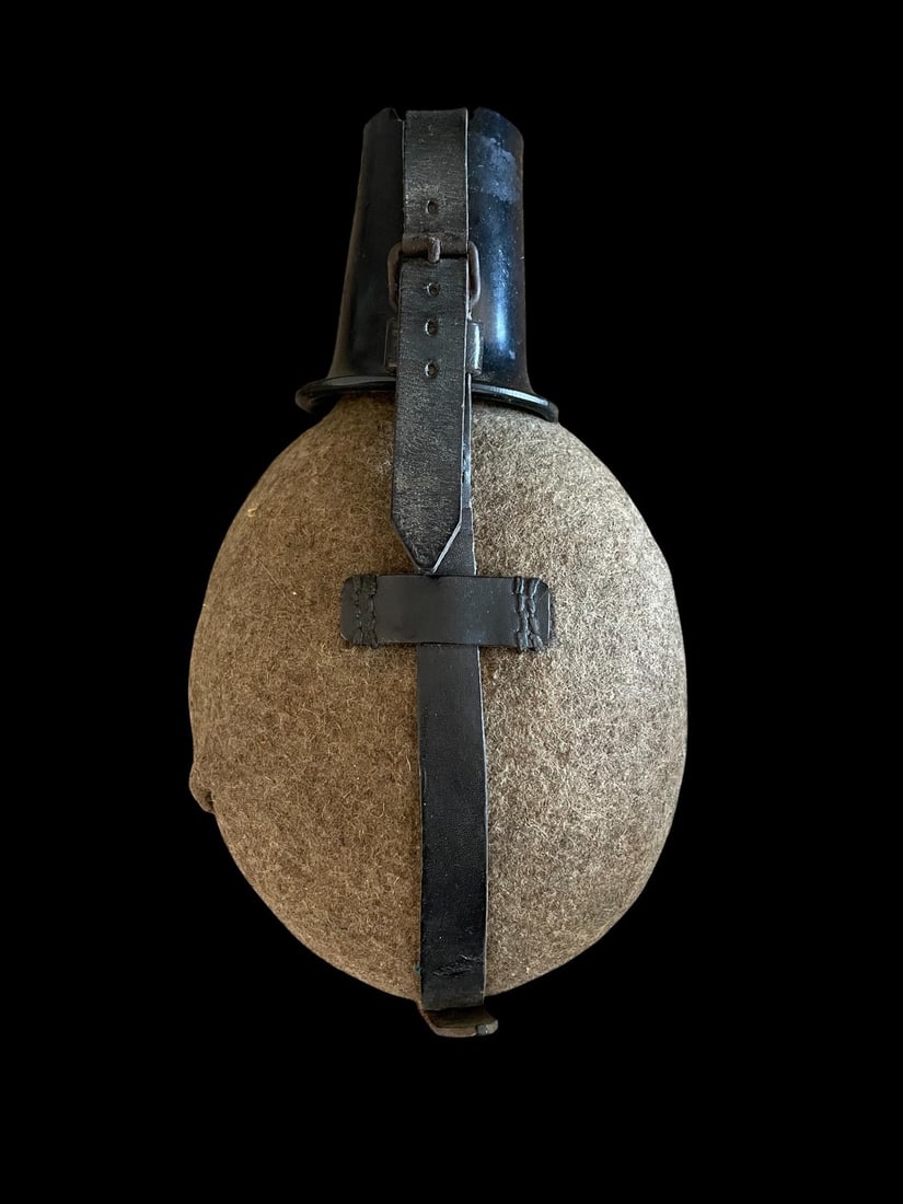 WWII German Army Canteen: A classic and essential piece of World War II field gear, this is an original German M31 Feldflasche 31 Canteen set, complete with its mess cup and leather carrying harness. This example features the