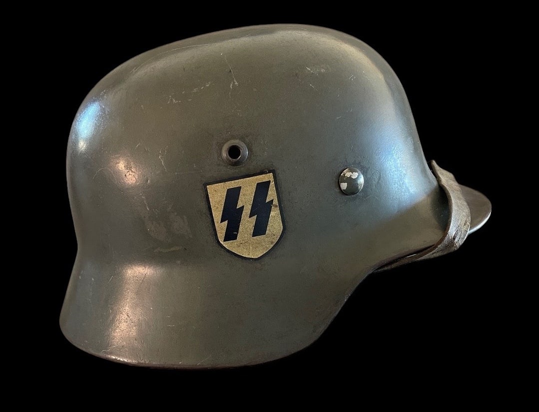 WWII Apple Green SS German M40 Double-Decal Waffen-SS Combat Helmet: A highly original WWII German M40 steel combat helmet bearing both the SS runes and national shields, retaining its wartime apple green finish and full interior fittings. The shell is stamped ET 66 Ei