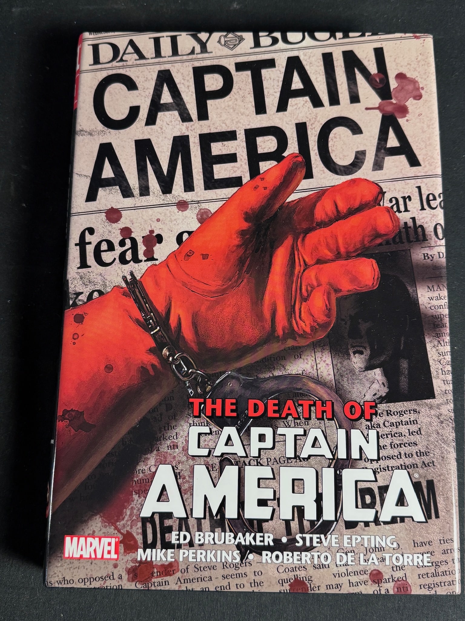 Captain America: The Death of Captain America Omnibus 1st Printing: A Marvel Omnibus hardcover graphic novel titled Captain America: The Death of Captain America. This volume collects issues 25 through 42 of the series. The work features writing by Ed Brubaker and