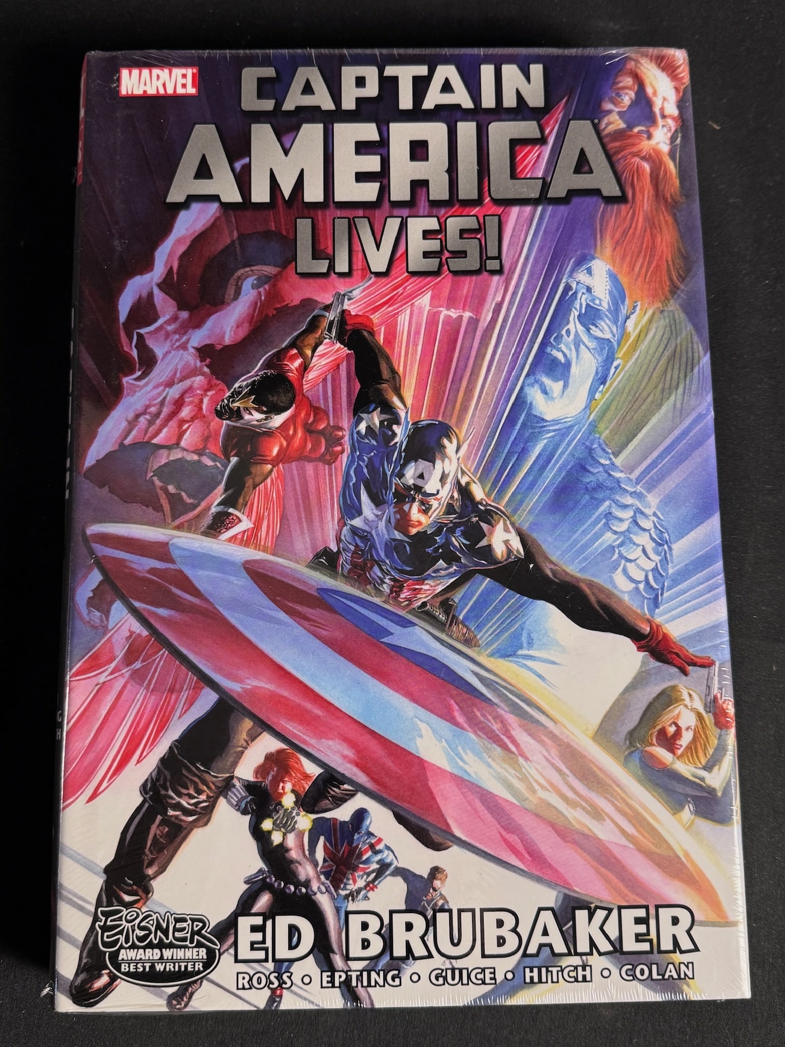 Captain America Lives Omnibus by Ed Brubaker 1st Printing: This Marvel Omnibus hardcover graphic novel is titled Captain America Lives! and is written by Ed Brubaker. The volume features artwork by Alex Ross, Steve Epting, Butch Guice, Bryan Hitch, and Gene