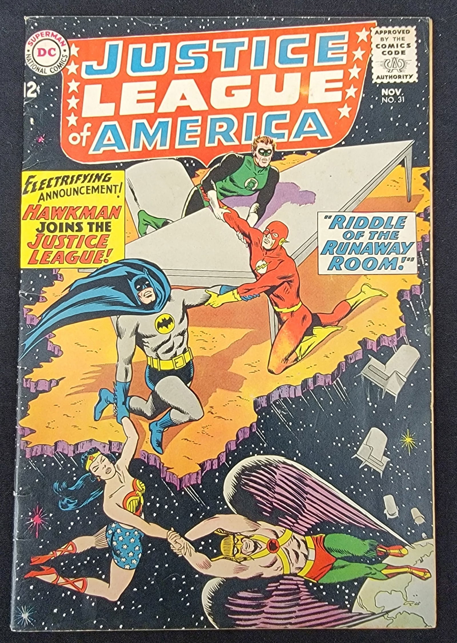 Justice League of America 31 - Hawkman Joins JLA: Justice League of America No. 31, published by DC Comics in November 1964. This Silver Age comic book features a 12-cent original cover price and includes the story Riddle of the Runaway Room. The