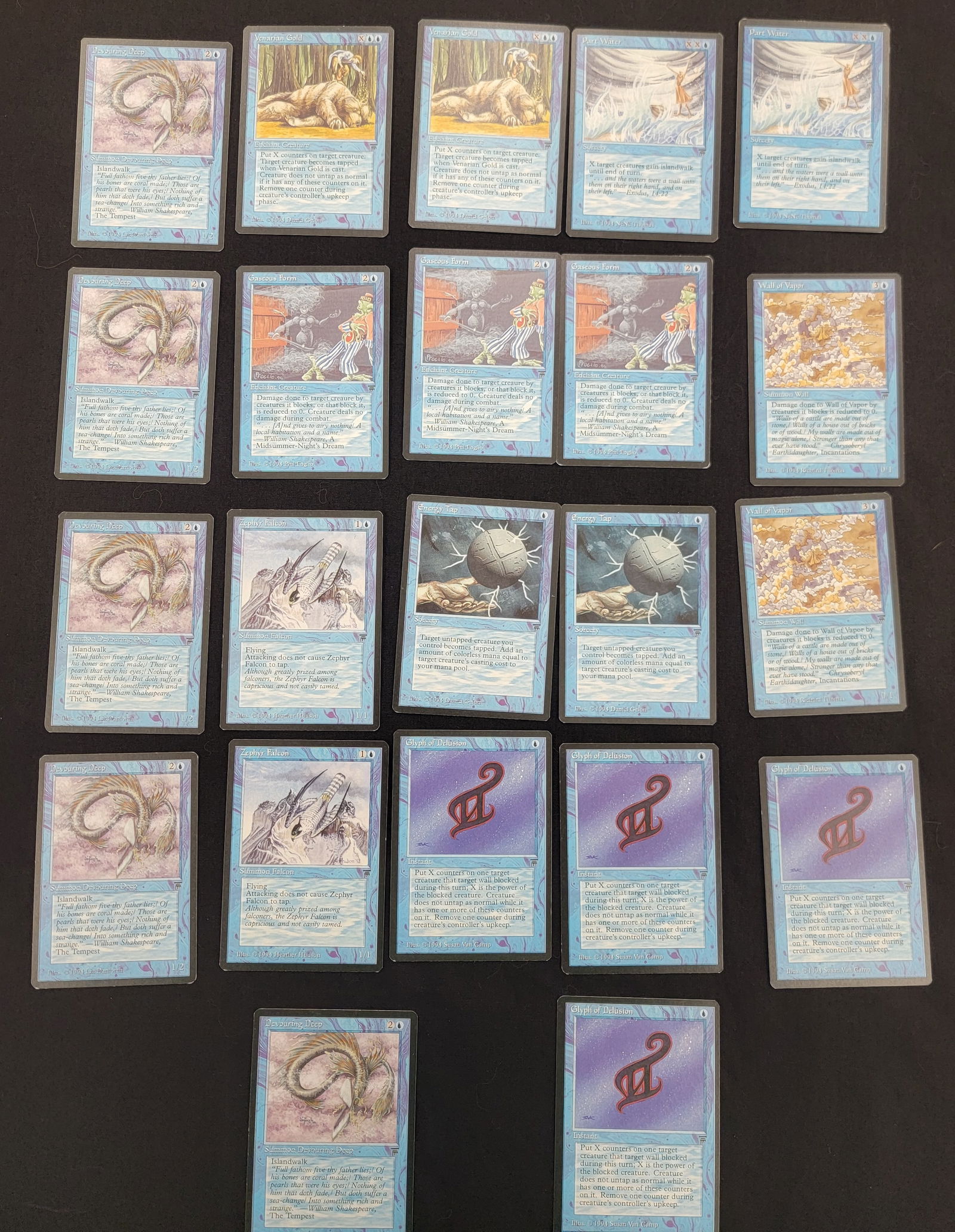 Magic The Gathering Legends Expansion Trading Cards: A collection of Magic: The Gathering trading cards from the 1994 Legends expansion set. This group primarily consists of blue spells and creatures. Specific card titles included in the lot are Devouri