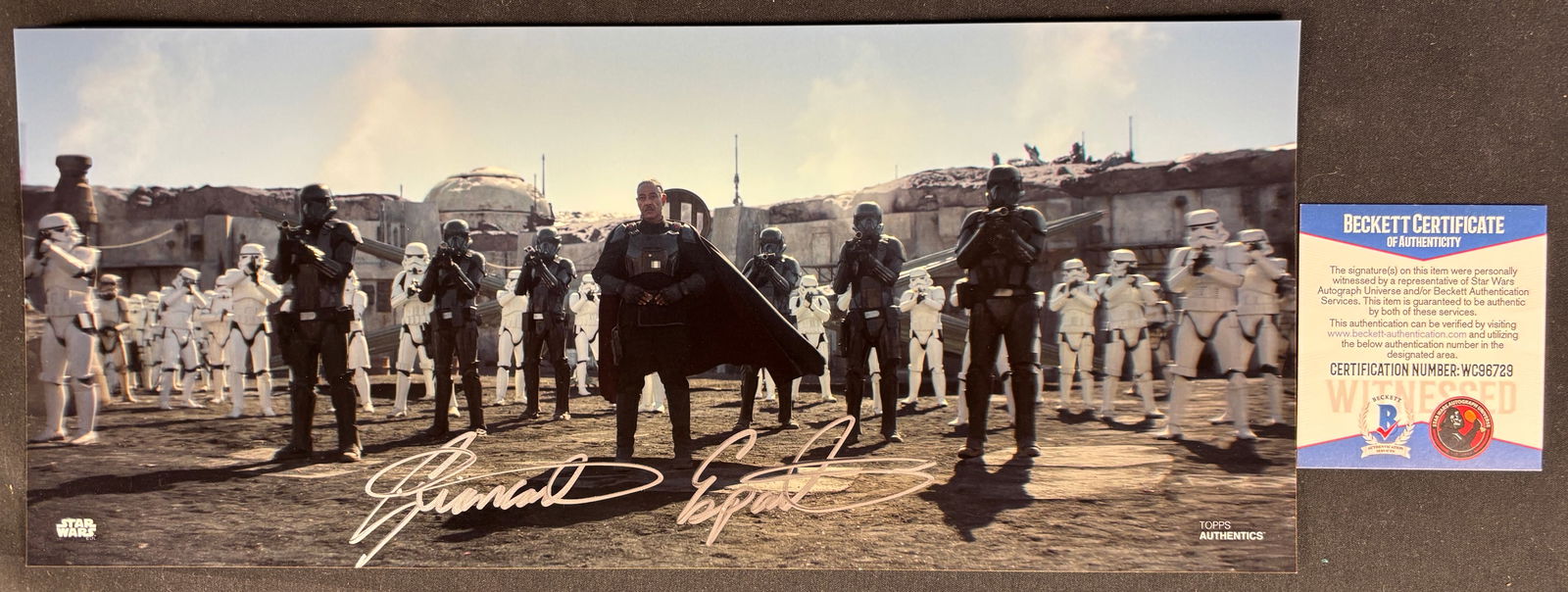 Giancarlo Esposito Signed Moff Gideon 12x18 Photo The Mandalorian Topps Authentics: A wide-format color photographic print from the television series The Mandalorian, depicting the character Moff Gideon, portrayed by Giancarlo Esposito, standing before a group of Imperial