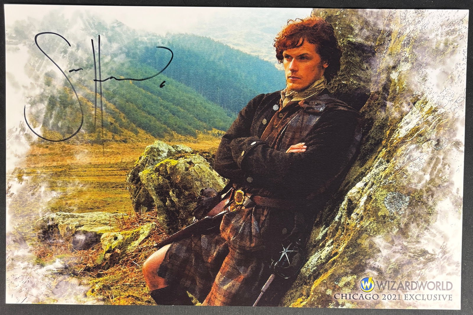 Sam Heughan Signed Outlander 11x14 Wizard World Chicago 2021 Exclusive Photo: This color photograph features actor Sam Heughan as the character Jamie Fraser from the television series Outlander. The print is a Wizard World Chicago 2021 Exclusive promotional piece. The image
