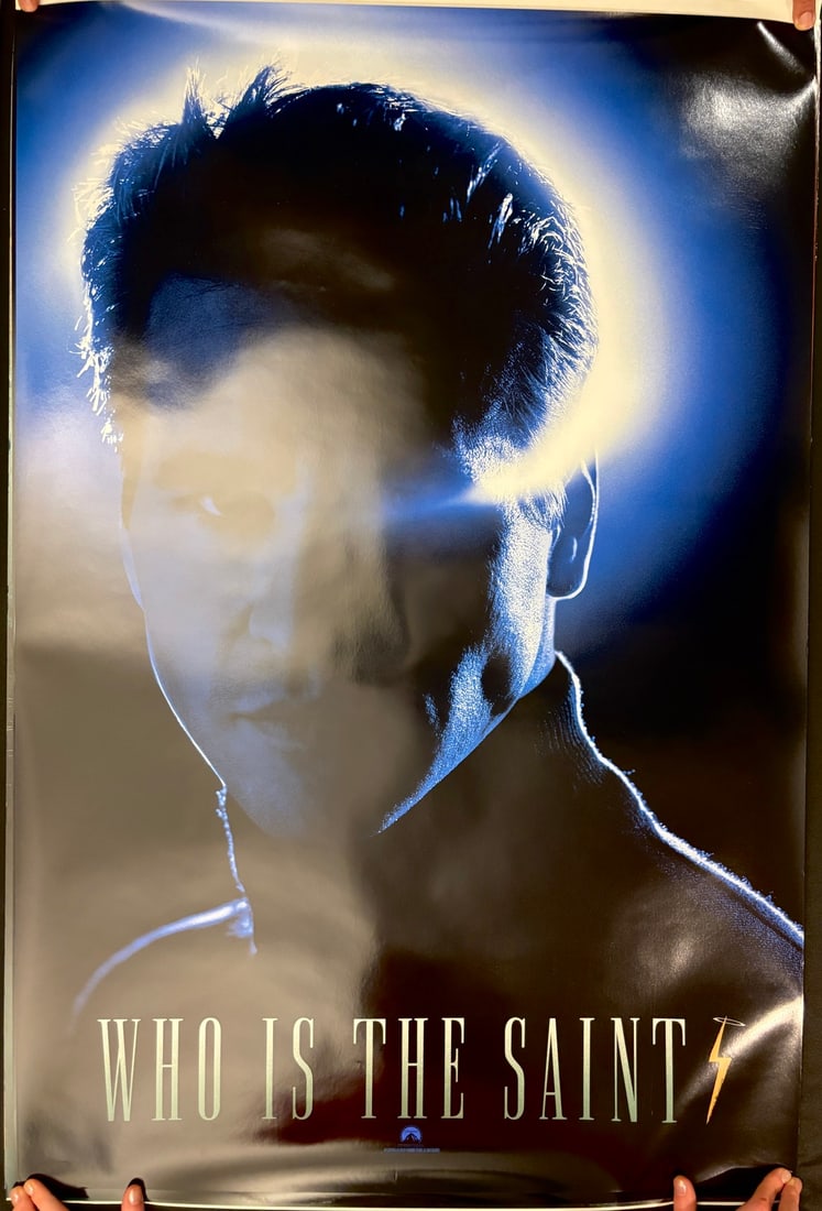 The Saint 1997 Original Double Sided Advance One Sheet Movie Poster: This original double-sided advance one sheet movie poster was produced for the 1997 Paramount Pictures film The Saint. The cinematic artwork features a high-contrast, blue-toned portrait of lead actor