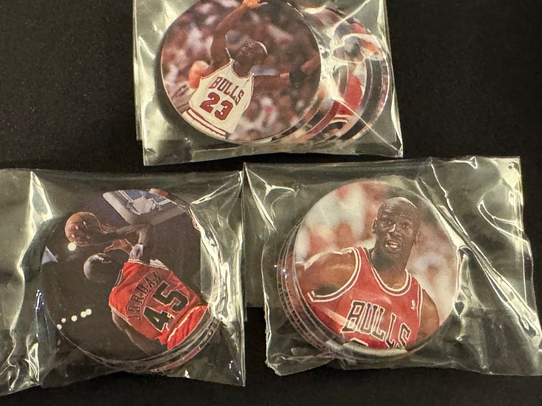 A Collection of 1995 Upper Deck Michael Jordan Basketball Milk Caps: A collection of 1995 Upper Deck Michael Jordan basketball milk caps, commonly referred to as pogs. These circular game discs are constructed from printed laminated paperboard and feature photographic