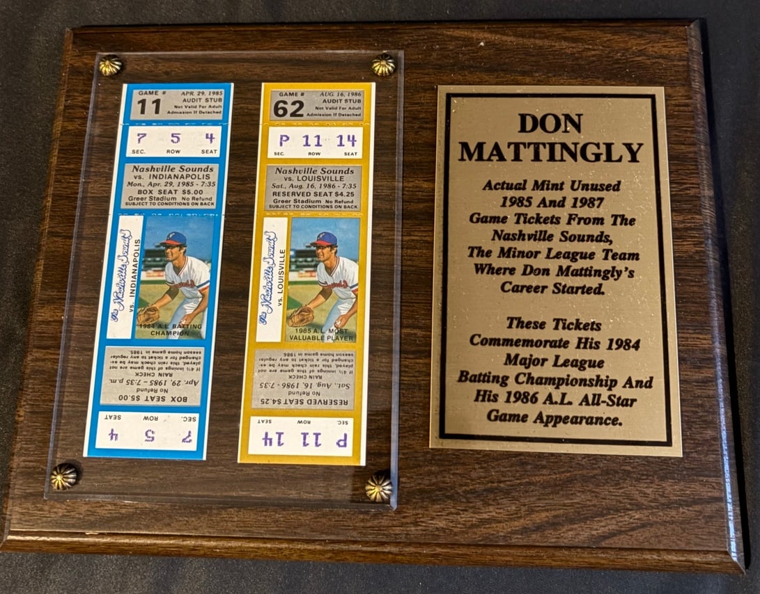 Don Mattingly Nashville Sounds Commemorative Plaque 1985 MVP Vintage Minor League Baseball Tickets: A commemorative memorabilia plaque honoring baseball player Don Mattingly and his tenure with the Nashville Sounds minor league team. The assembly consists of a dark wood-grain finish board mounting a