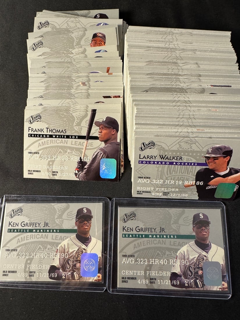 A Collection of 1995 Studio Baseball Cards - Ken Griffey Jr. MINT: A collection of 1995 Studio baseball trading cards. The cards are designed with a matte silver-gray background incorporating a faint eagle and crest motif. Each card features a player portrait, 1994 s