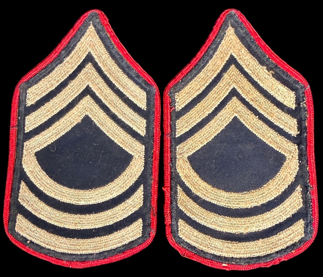WWII US Army Staff Sergeant Chevrons Red Border CAP: This lot features a scarce and highly desirable piece of US Army insignia: an original pair of World War II Era US Army Staff Sergeant Chevrons. These chevrons are distinct for their construction and