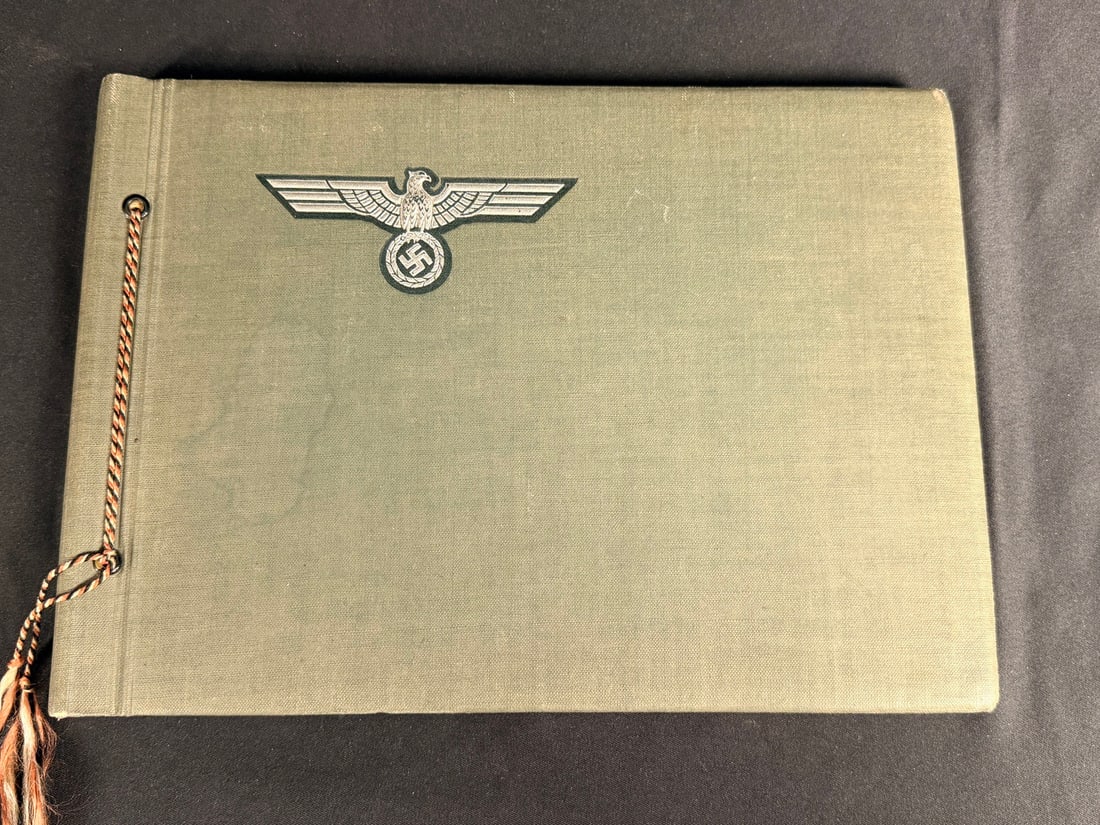 1930s German Army Photo Album: Aproximately 20 photos. Early German Army pics. This is a period-authentic German Heer (Army) photo album dated 1935. The exterior is constructed of olive-green cloth over boards. The front cover feat