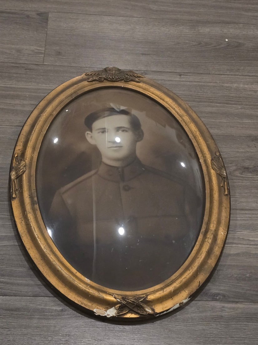 WWI US Army Wall Hanger Photo: This is a World War I-era military portrait featuring a US Army soldier. The subject is depicted in a large-format, oval, sepia-toned photographic print. He is wearing a standard M1917 high-collar tun