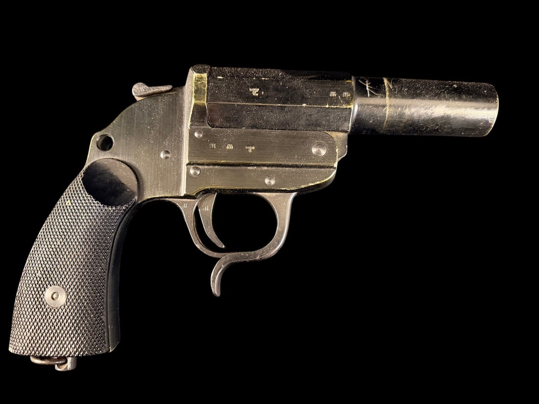 WWII German Flare Pistol: A German World War II era Leuchtpistole 42 (LP42) single-shot break-action flare pistol manufactured by Erma-Werke. The left side of the frame is stamped with the manufacturer code ayf above the produ