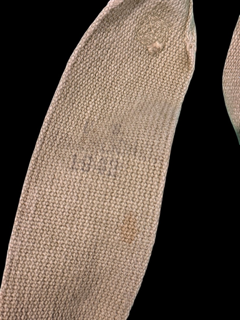 WWII US Army M1936 Field Suspenders: US military M1936 field suspenders constructed from heavy-duty khaki Olive Drab No. 3 canvas webbing. This pattern features two adjustable shoulder straps joined by a Y-shaped back strap. The assembly