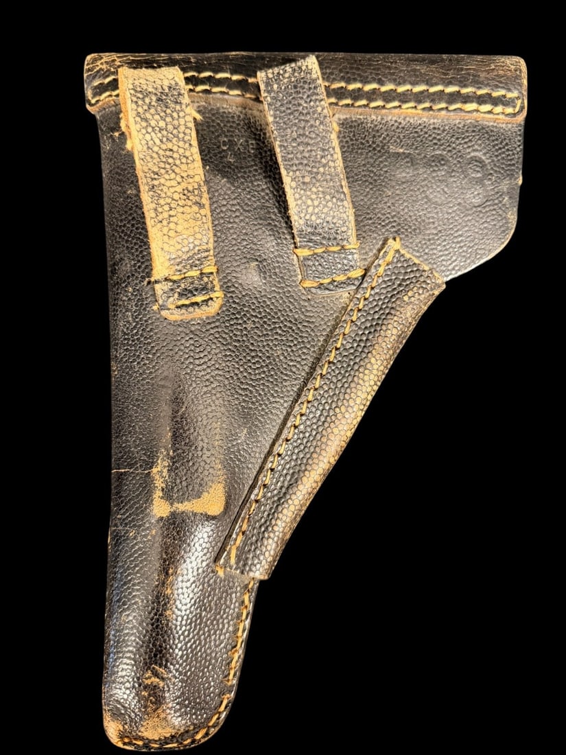 WWII Walther P-38 Holster 1944 Date: This is a German military soft-shell holster designed for the Walther P.38 pistol. The item is constructed from black pebble-grained leather and features a large top flap secured by a single leather s