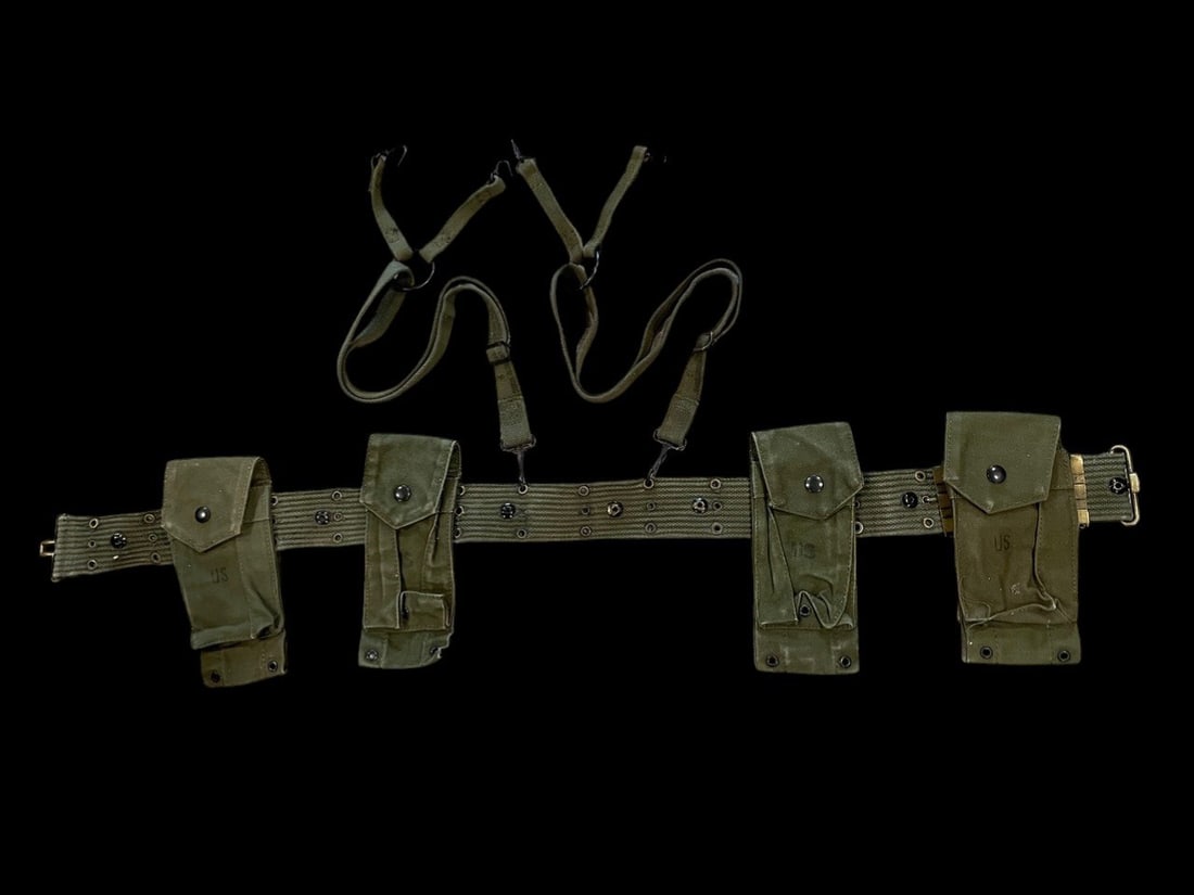 US Army Vietnam Era Rig: A set of United States military individual load-carrying equipment in Olive Drab canvas, dating to the Vietnam War era. The grouping includes an M1956 individual equipment belt, M1956 H-style suspende
