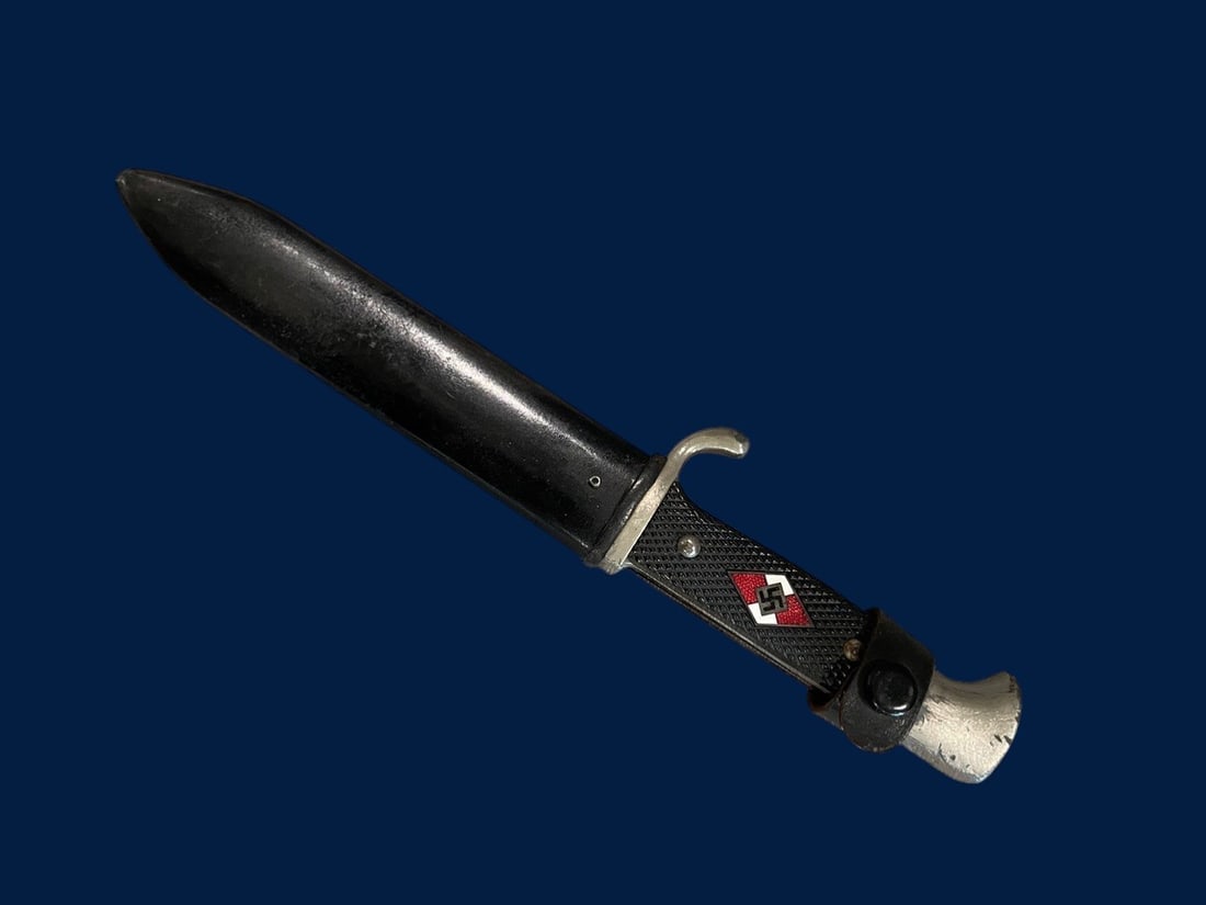 WWII Hitler Youth Dagger: This Hitler Youth member dagger is a mid-period production example featuring the manufacturer mark for Carl Julius Krebs of Solingen. The single-edged steel blade has a rounded tip and does not featur