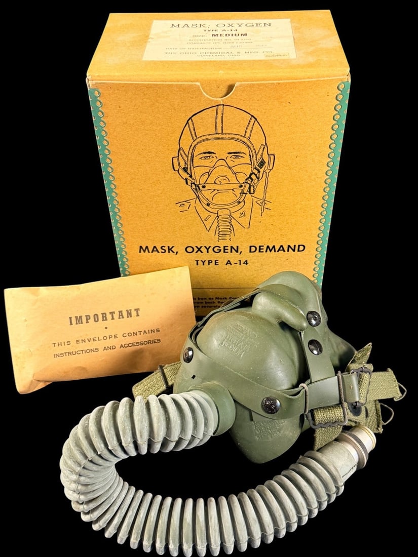 WWII Type A-14 Oxygen Mask in Original Box: This is a United States Army Air Forces (USAAF) Type A-14 demand-type oxygen mask kit, manufactured by The Ohio Chemical & Mfg. Co. of Cleveland, Ohio. The kit includes the olive drab green rubber fac