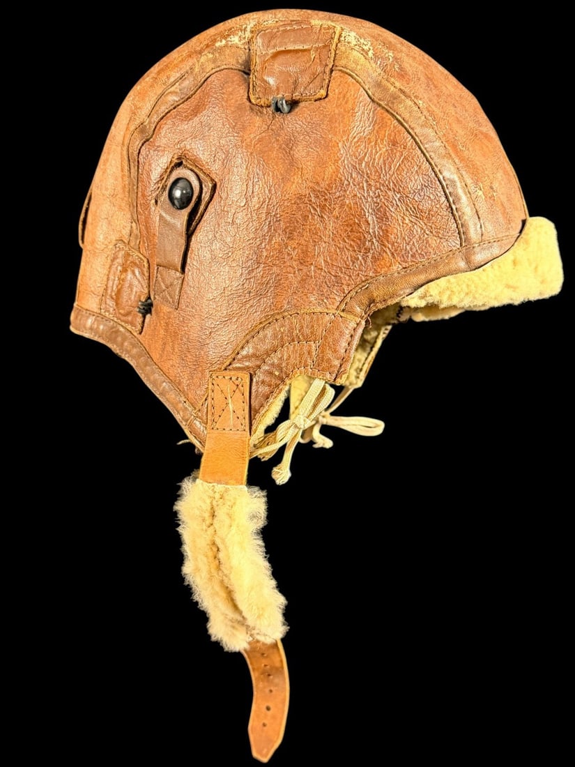 WWII AAF Type B-5 Leather Flight Helmet: This is a United States Army Air Corps Type B-5 winter flying helmet from the World War II era. The helmet is constructed from multi-panel brown leather with a full interior lining of thick, natural c