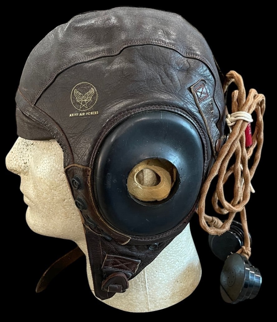 WWII Type A-11 Flight Helmet with Avionics: A World War II-era US Army Air Forces Type A-11 intermediate flight helmet manufactured by Bradley-Goodrich Inc. The helmet is constructed from a dark brown sheepskin leather outer shell with a tan su