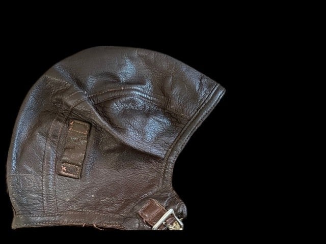 WWII USN USMC Flight - Parachute Training Helmet Type NAF 1092-73: This is a US Navy Model NAF 1092-73 intermediate-weight leather flight helmet produced during World War II. The exterior is constructed from dark brown pebbled-grain goatskin leather featuring a multi