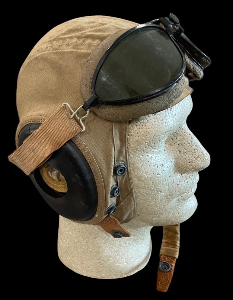 WWII Type AN-H-15 Helmet with Flight Goggles: This lot consists of a United States Army Air Forces USAAF Type AN-H-15 summer-weight flying helmet paired with a set of Polaroid aviation goggles. The helmet is constructed from tan cotton twill and