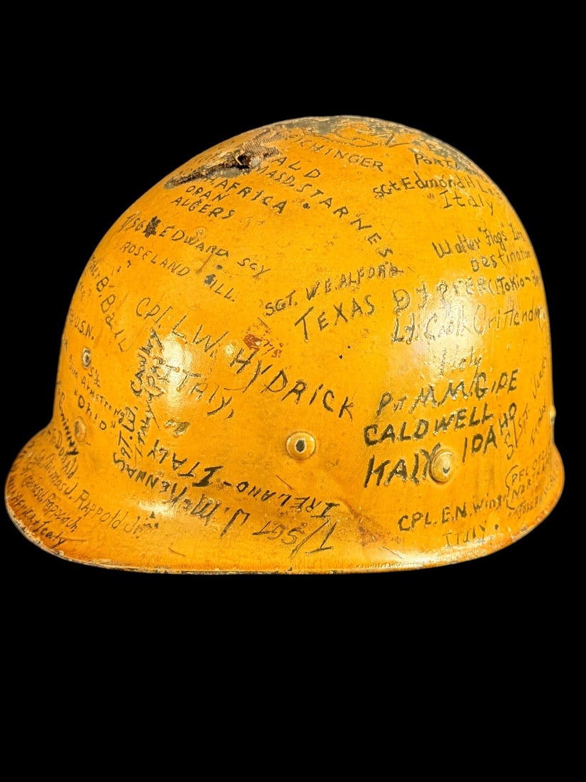 WWII 1st Division Signed Helmet: This is a World War II era US M1 helmet liner constructed of high-pressure molded fiber composite. The exterior surface is finished in yellow paint and serves as a medium for numerous hand-inked inscr