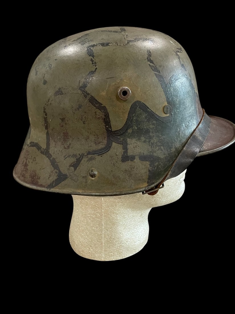 WWI German M16 Camo Helmet: A fine and completely original German World War I M16 combat helmet with period-applied camouflage finish, displaying a beautiful and untouched example of the distinctive hand-painted multicolor