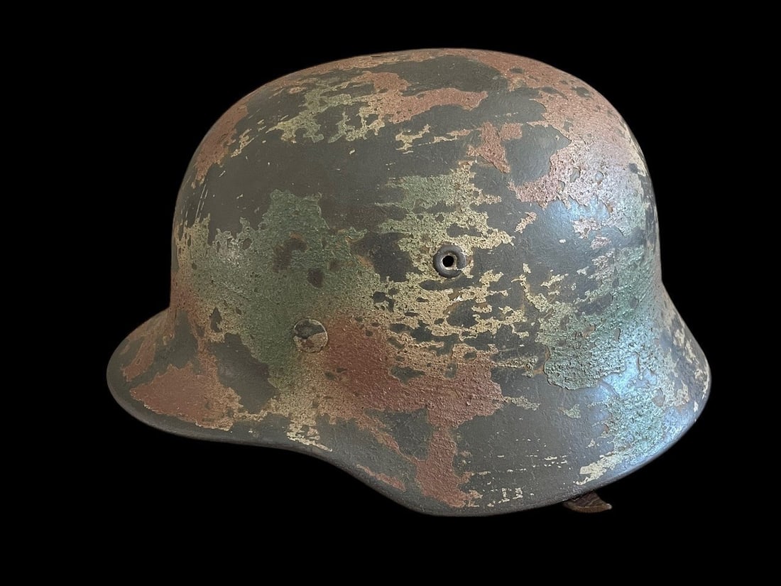 Outstanding German WWII M40 Army (Heer) Combat Helmet with Three-Color Camouflage: This lot features a museum-grade example of a German Model 1940 (M40) (SD) Army (Heer) Combat Helmet featuring a superb, period-applied, three-color camouflage paint scheme. The M40 model is identifia