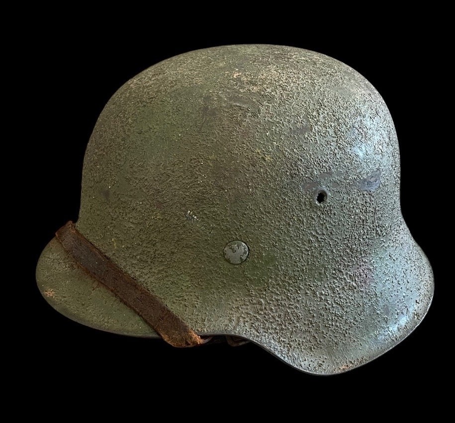 WWII German M40 Rough Camo with strap: German WWII M40 Combat Helmet with Heavy Textured Camouflage and ChinstrapThis lot offers an exceptional, late-war aesthetic piece: a German Model 1940 M40 Combat Helmet that was issued without decals