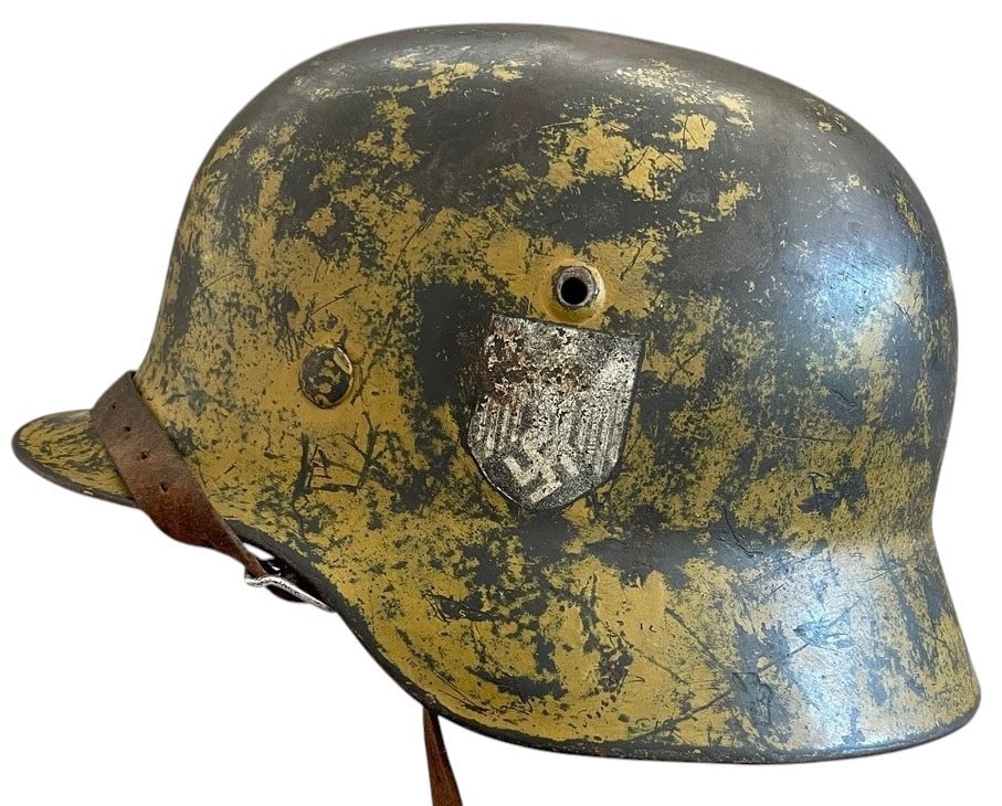WW2 German Army SD DAK Camoflage Helmet: A fine and completely original World War II German Army M40 combat helmet, factory produced by Eisenh?ttenwerke Thale and stamped ET64 with lot number 1221. This example retains its single Heer decal