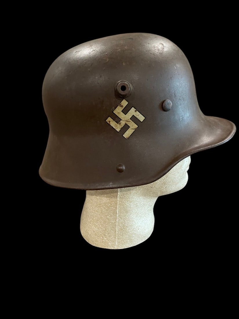 WWII German M18 Fire Helmet: Transitional helmet with white emblem used for fire services.