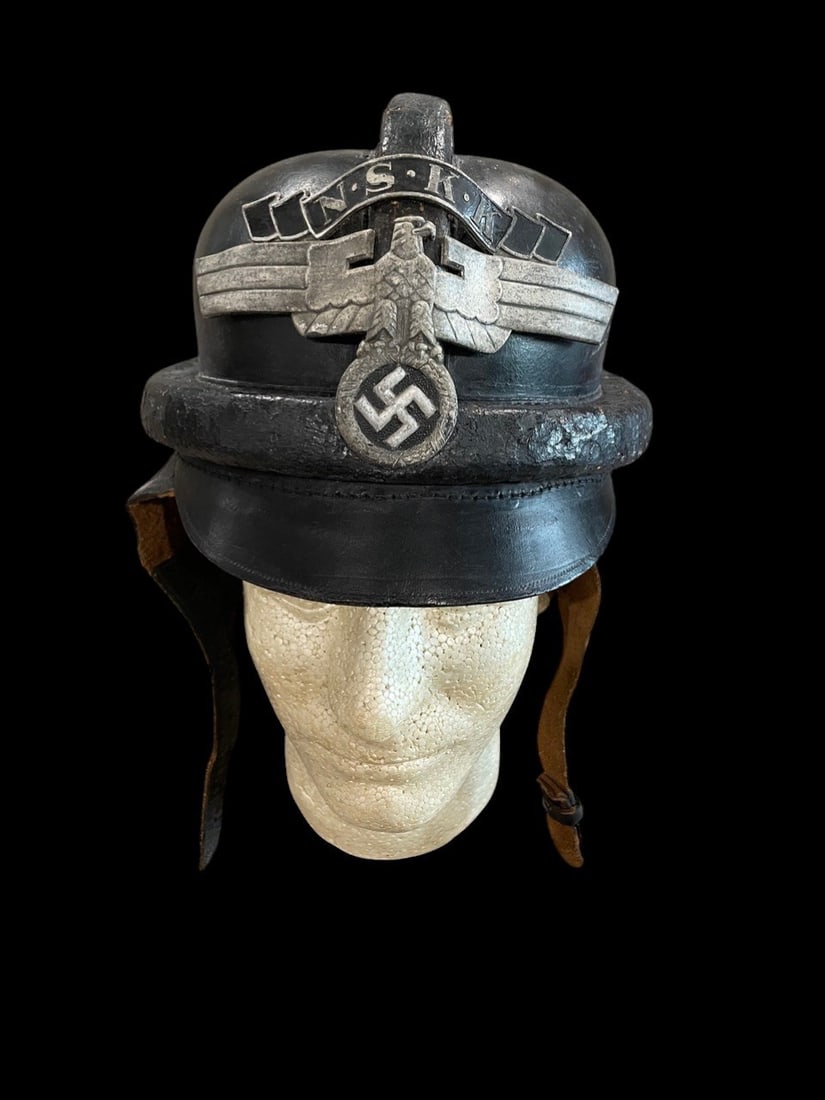 WWII German NSKK Helmet: Rare WWII German NSKK Black Leather Crash Helmet with Visor and Metal InsigniaThis lot features a rare and distinctive piece of paramilitary organizational headgear: an Original WWII German National S