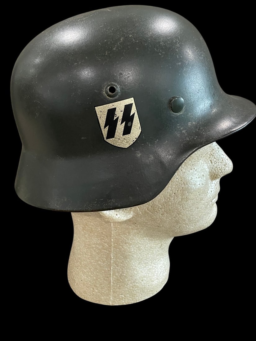 WWII German M38 SS Double Decal Helmet: This lot presents a highly sought-after example of a German Model 1938 (M38) Double Decal Combat Helmet, definitively issued to the Waffen-SS during the early years of World War II. The helmet shell w
