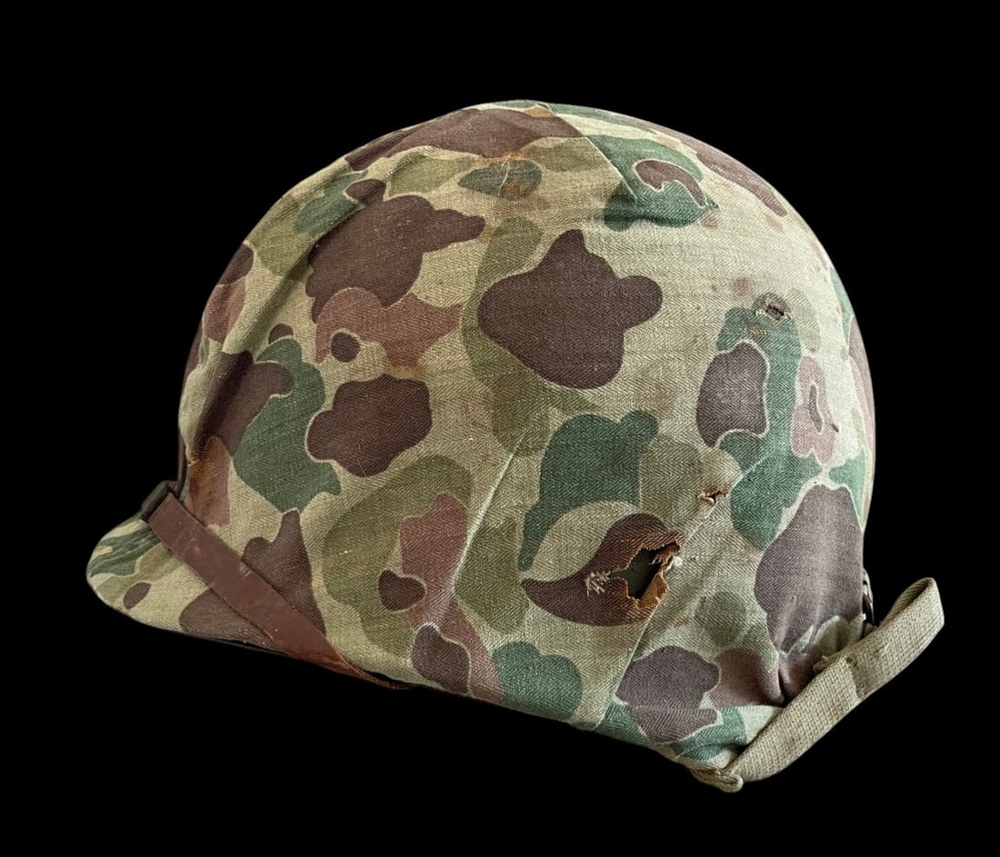 WWII USMC M1 Helmet FS FB with Camo Cover: This United States Marine Corps M1 steel combat helmet assembly includes a high-pressure liner and a first-pattern reversible camouflage cover. Front seem and Fixed bail. The steel pot features sewn-o