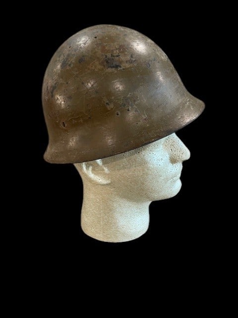WWII Type 90 Japanese Combat Helmet Named and Unit Idd: This is an original WWII Imperial Japanese Army Type 90 steel combat helmet. The shell features a domed shape with a flared rim and ventilation holes located near the crown. The exterior retains porti