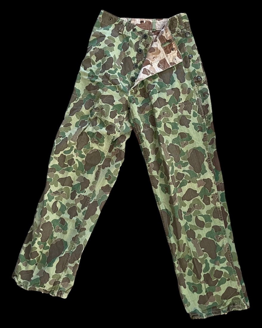 Rare WWII USMC Reversible Frog Skin Camo HBT Pants P44: United States Marine Corps M1944 P44 utility trousers featuring the reversible frog skin camouflage pattern. The garment is constructed from herringbone twill HBT fabric, printed with a green-dominant