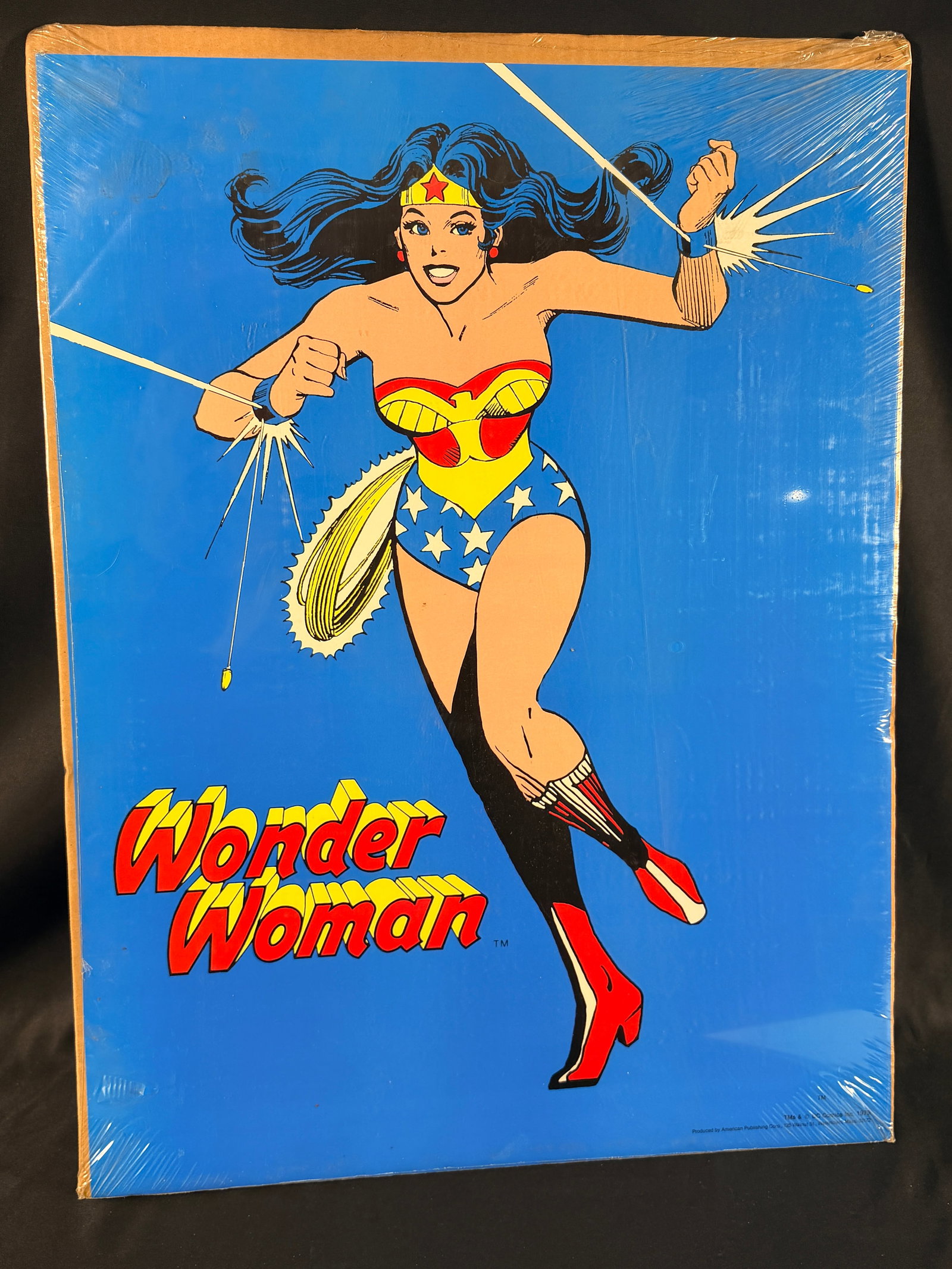 1978 DC Comics Wonder Woman Large Format Mounted Print by American Publishing Corp: This is a vintage large-format color print featuring Wonder Woman, produced in 1978 by American Publishing Corp. under license from DC Comics Inc. The artwork depicts Wonder Woman in a classic dynamic