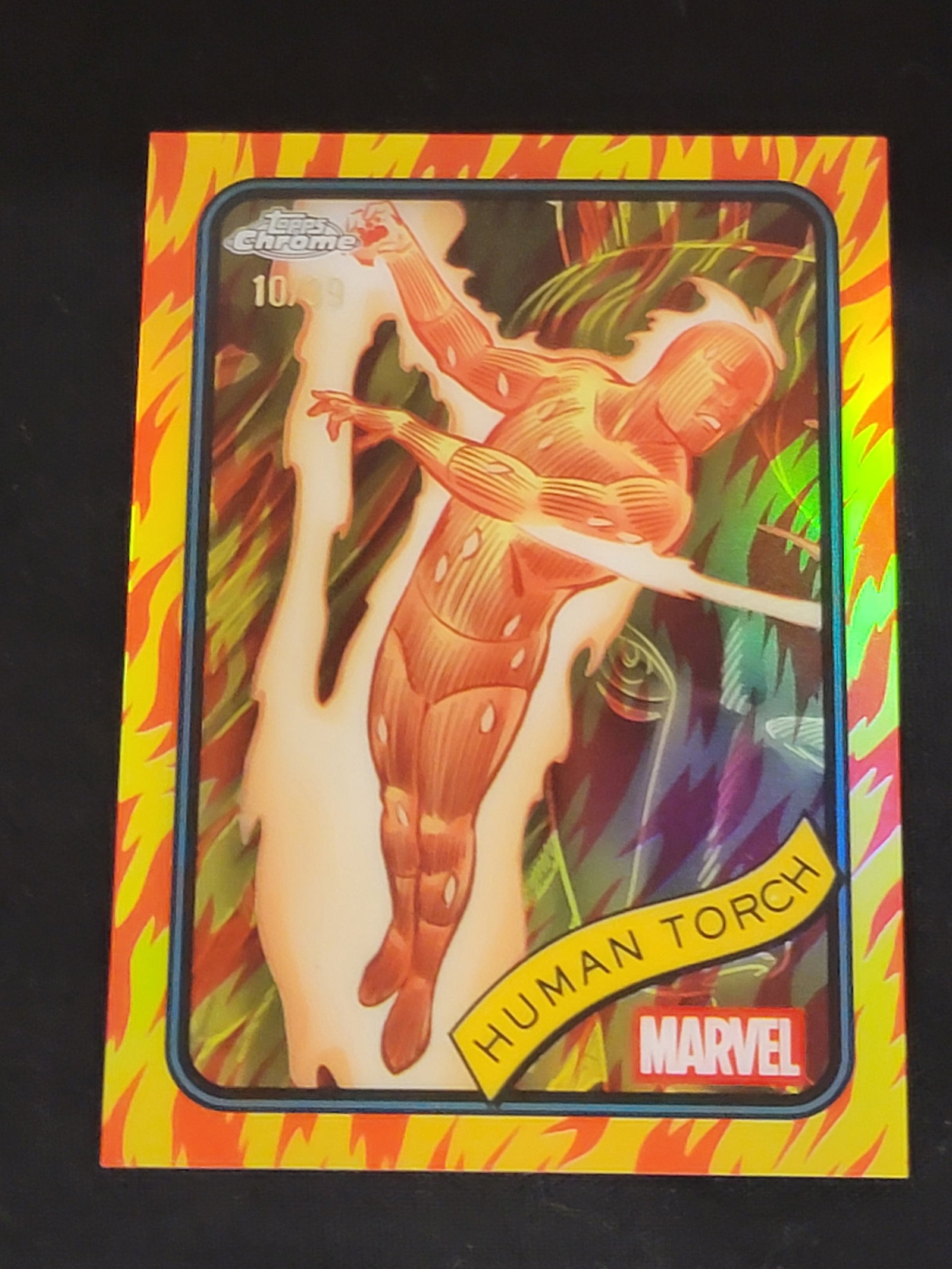 2025 Topps Chrome Marvel Human Torch No.40 Serial Numbered 10/99 Trading Card: This 2025 Topps Chrome Marvel trading card features the character Human Torch, designated as number 40 in the set. The item is a limited-edition parallel, hand-stamped with the serial number 10/99 on 