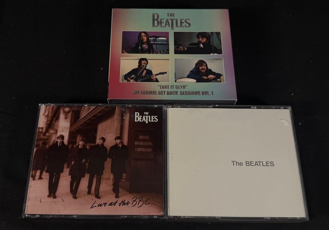 Beatles CD Box Lot: Three CD releases including Live at the BBC, Take It Glyn (Get Back Sessions Vol.1 bootleg), and The Beatles (White Album) 2CD.