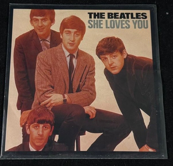 The Beatles 'She Loves You' / 'I'll Get You' Picture Sleeve: Collectible Beatles picture-sleeve presentation for the classic 1963 single 'She Loves You' backed with 'I'll Get You.'