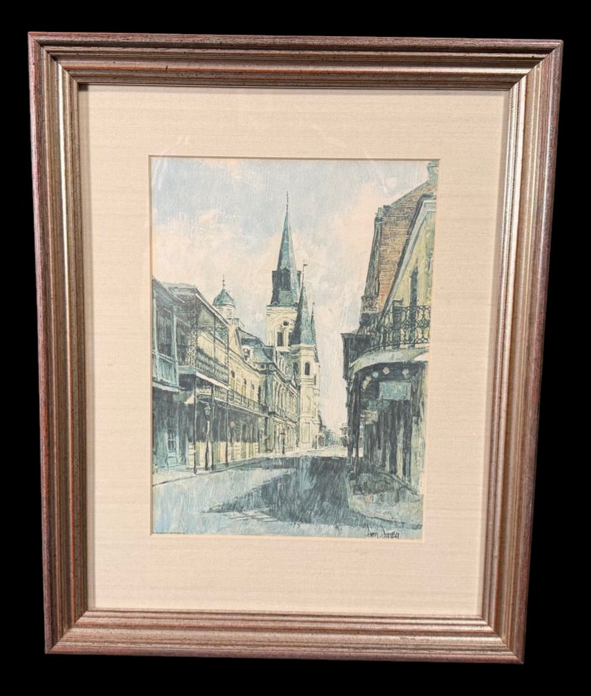 Signed New Orleans French Quarter Street Scene by: Full title: Signed New Orleans French Quarter Street Scene by Don Davey Framed signed architectural print depicting a French Quarter-style street with cathedral spires and wrought-iron balconies.