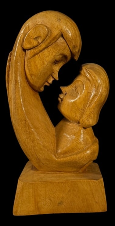Hand-Carved Mother and Child Sculpture: Smooth hand-carved wooden sculpture depicting a mother embracing her child in a stylized modern form.
