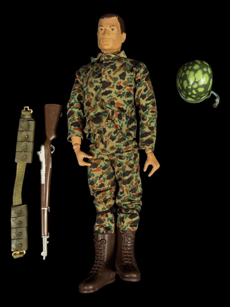 Vintage 1964 G.I. Joe Camouflage Soldier Figure: 1964 G.I. Joe camouflage Action Soldier with helmet, rifle, and ammunition belt.