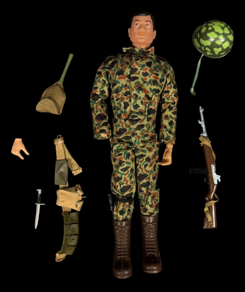 Vintage 1964 G.I. Joe Combat Soldier Figure: 1964 G.I. Joe Action Soldier wearing camouflage uniform with rifle, knife, helmet, and combat equipment. Broken hand.